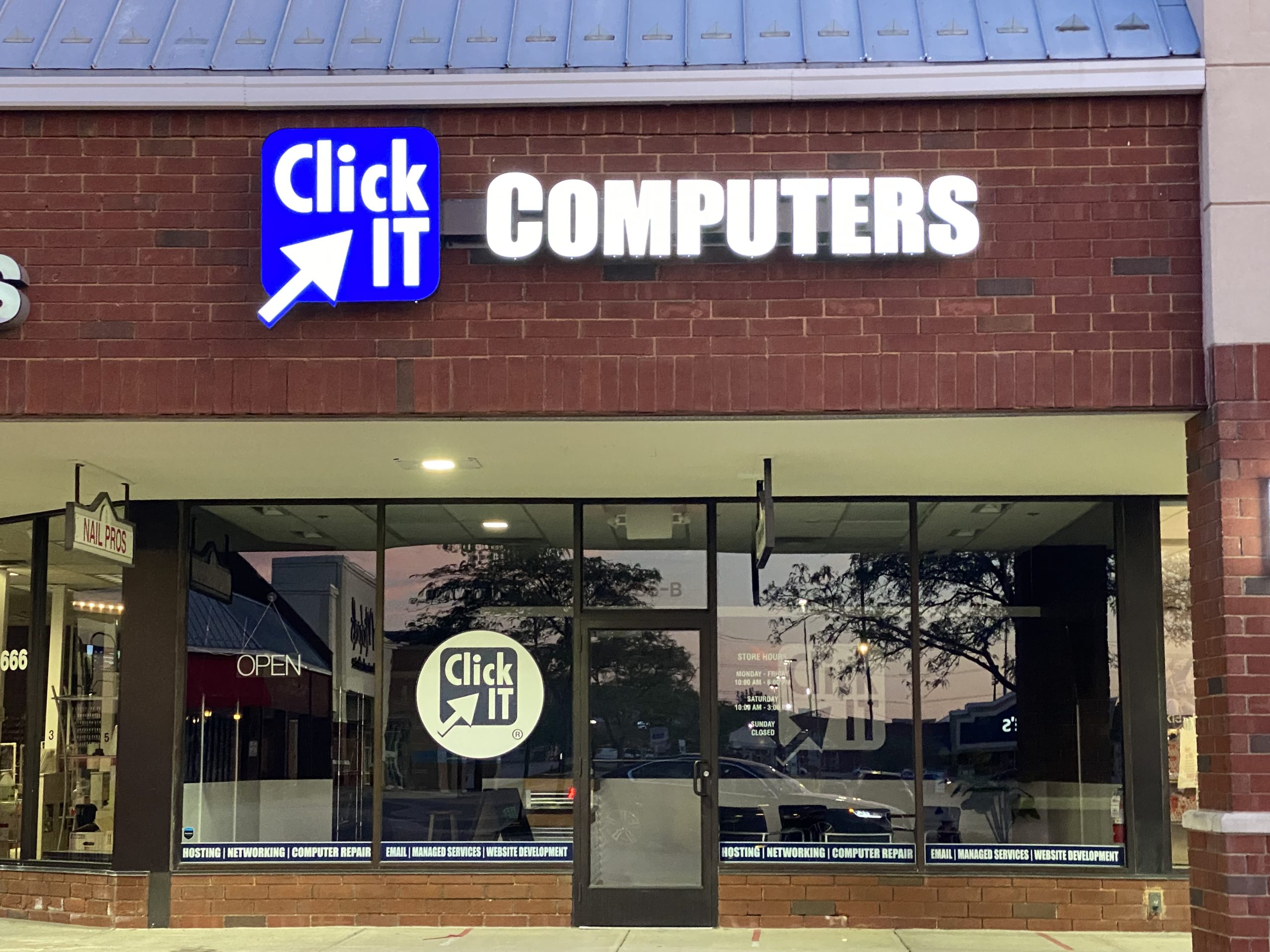 Illuminated Click IT Computers sign closeup